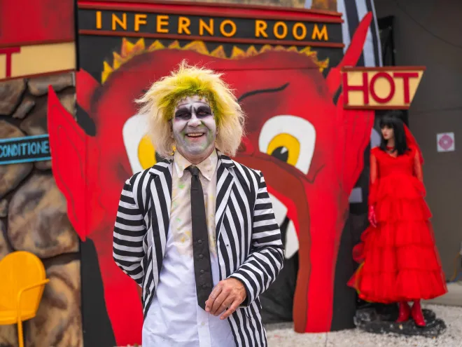 a person in a Beetlejuice costume in front of a display that says Inferno Room at the Halloween on Central event in St. Pete