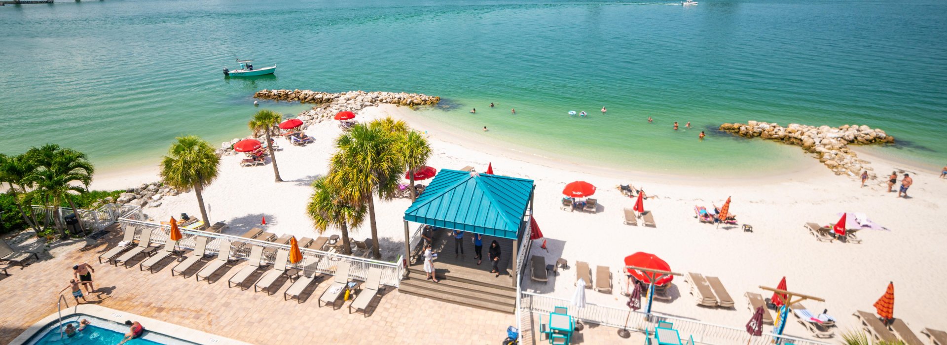 An overview of pool and beachfront of Dolphin Beach Club.