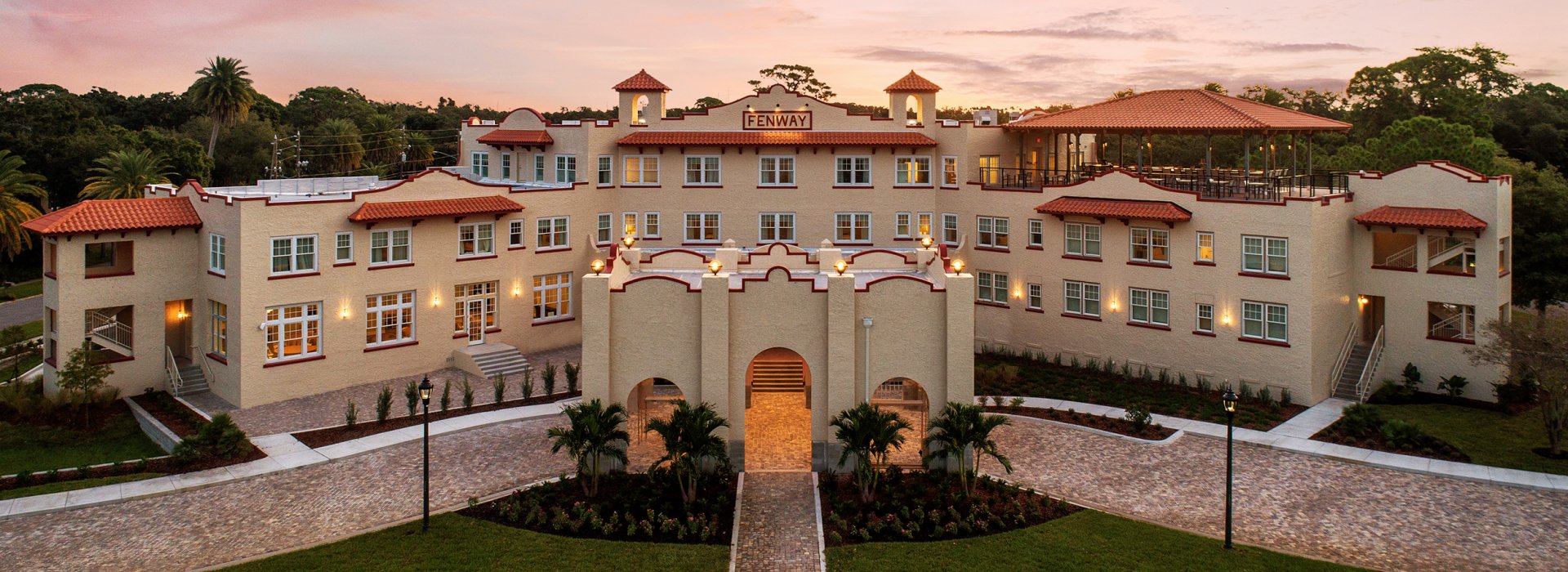 An aerial view of a large hotel at sunrise