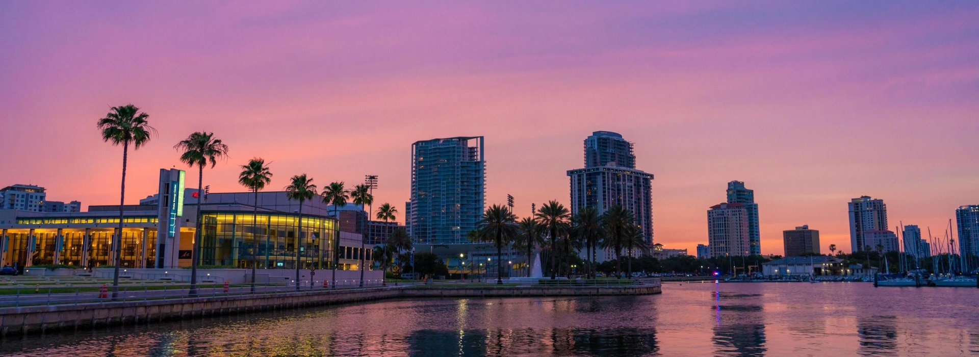 A vibrant pink and purple sunset over the Saint Pete Waterfront District.