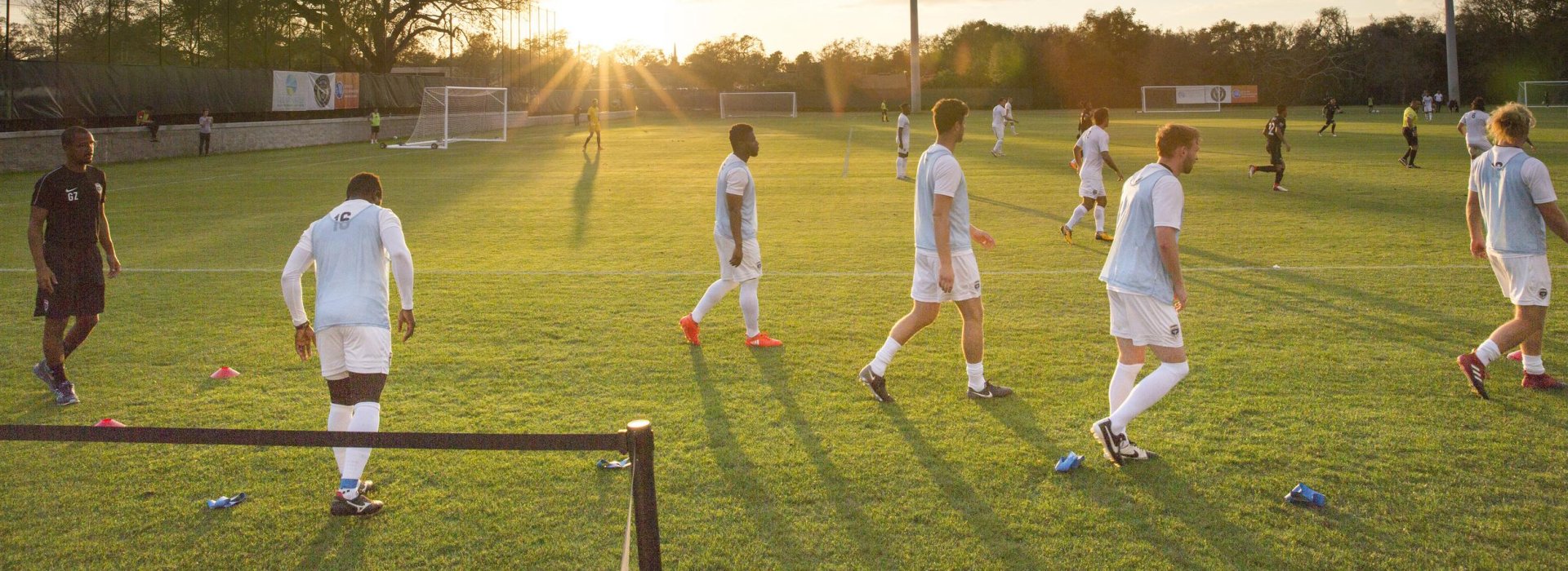 Soccer Players on the field near sunset