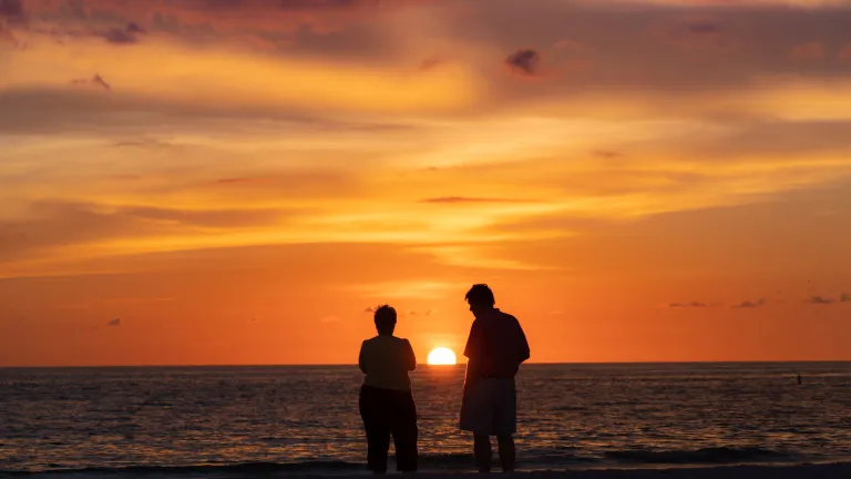 A couple watching the sunset in St. Pete Beach.