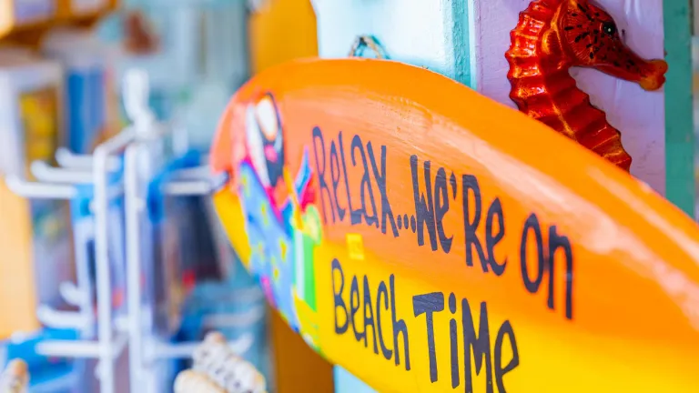 A colorful store sign says Relax, We're on Beach Time