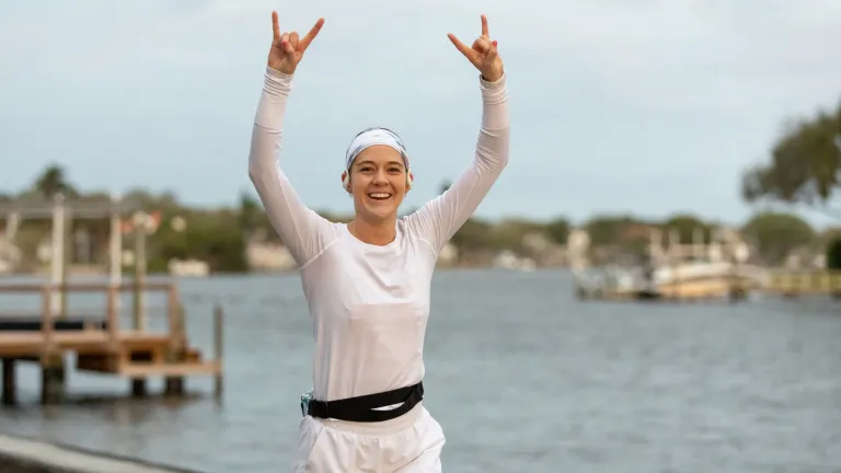 a young woman runs next to Coffee Pot Bayou during the St. Petersburg Distance Classic