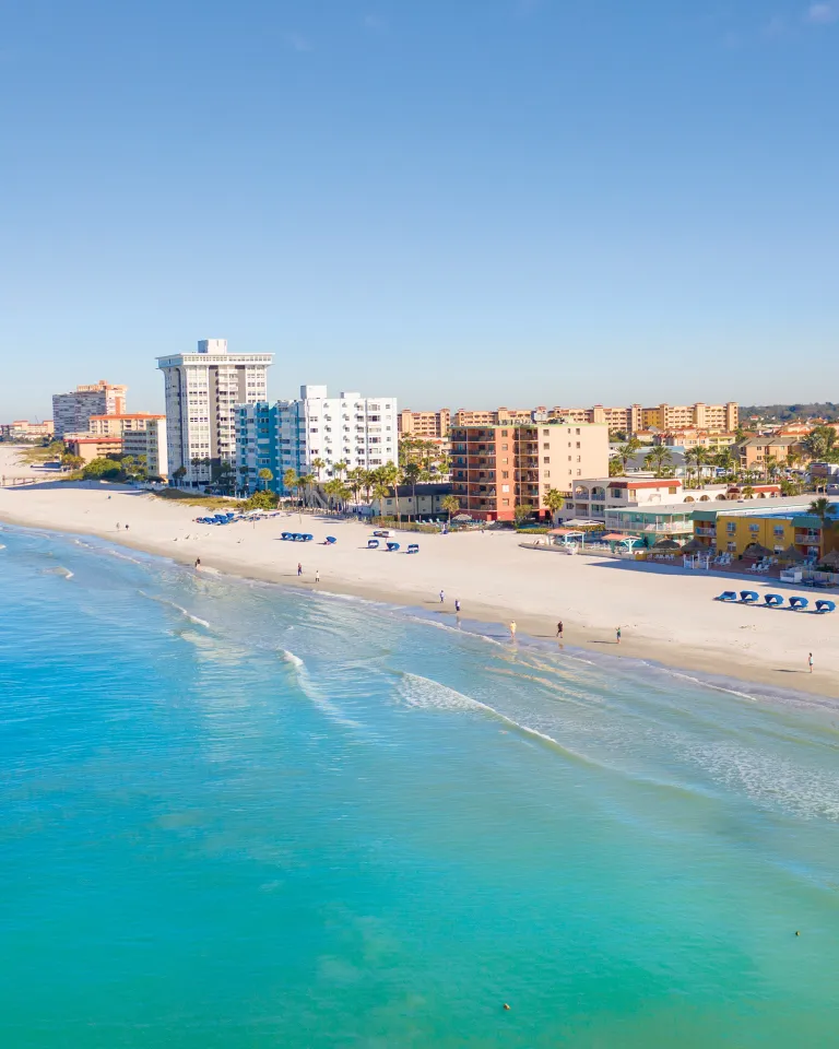 Aerial view of North Redington Beach with calm, blue-green Gulf waters to the west and condos to the east