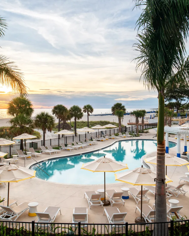 The pool at Sirata Resort with a view of St. Pete Beach horizon during sunset