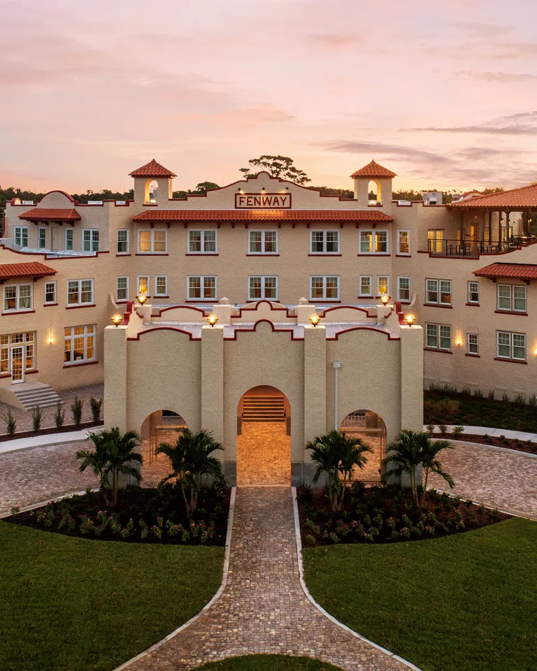 An aerial view of a large hotel at sunrise