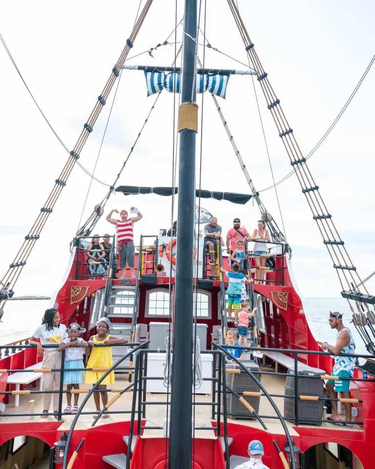 Families on the deck of the bright red Captain Memo Pirate Cruise in Clearwater Beach