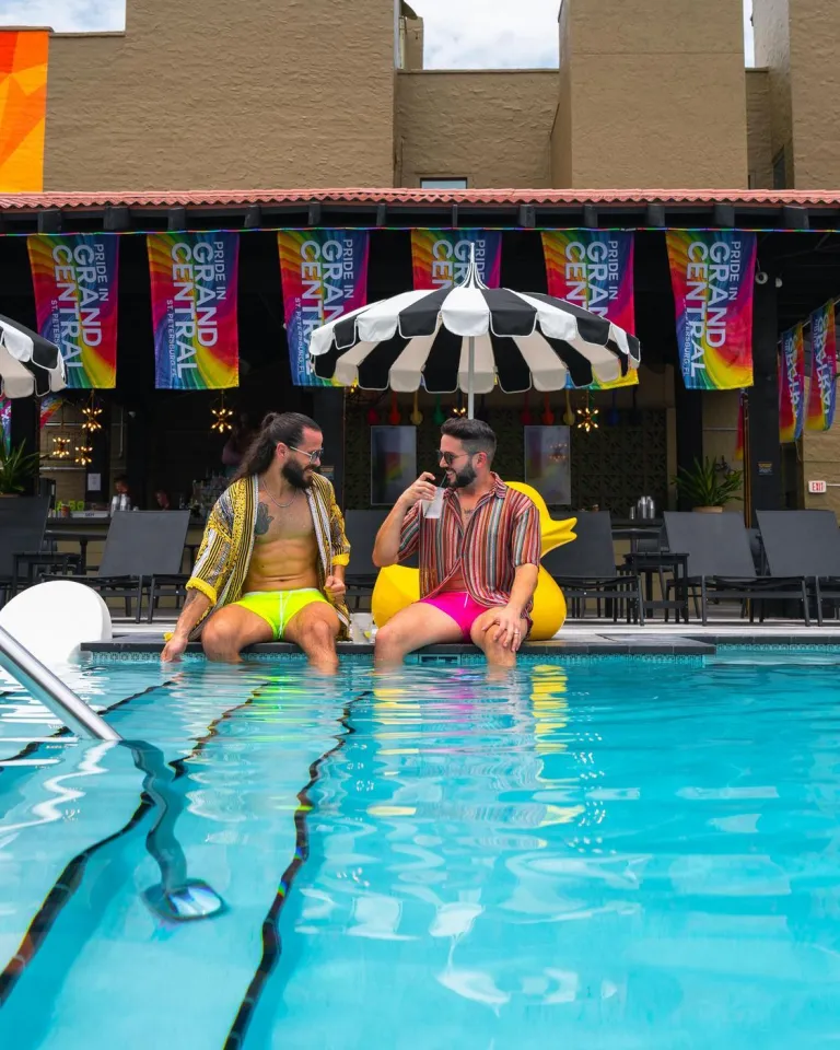 two men sitting on the edge of the pool at The Wet Spot next to the Mari Jean Hotel in St. Pete