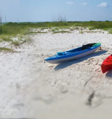 Kayakers taking a break in Caladesi Island white sands
