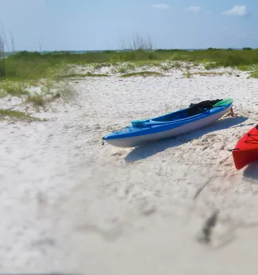 Kayakers taking a break in Caladesi Island white sands