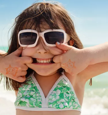 A girl making a funny smile on a beach in St. Pete/Clearwater