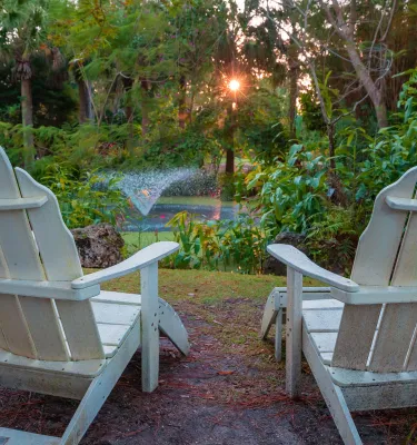 Adirondack chairs facing the fountain at Florida Botanical Gardens