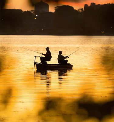 Two men fishing at sunset in Lake Seminole