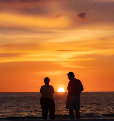 A couple watching the sunset in St. Pete Beach.