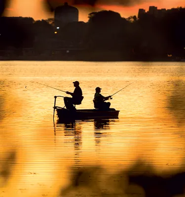 Silhouette of two men fishing at the Seminole Lake during sunset