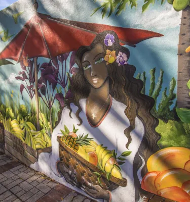 Un mural de una dama sosteniendo una canasta de frutas de los Jardines Botánicos de Florida