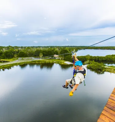 A man descends a zip line at Empower Adventures