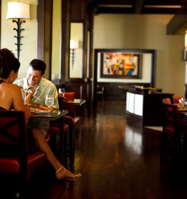 A couple enjoying a meal in an indoor setting of Caretta restaurant.