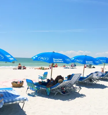 Sillas azules y sombrillas de Postcard Inn en St. Pete Beach