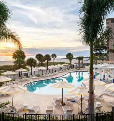 The pool at Sirata Resort with a view of St. Pete Beach horizon during sunset