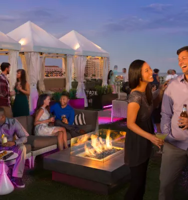 Several people enjoying drinks at The Canopy rooftop in St. Pete