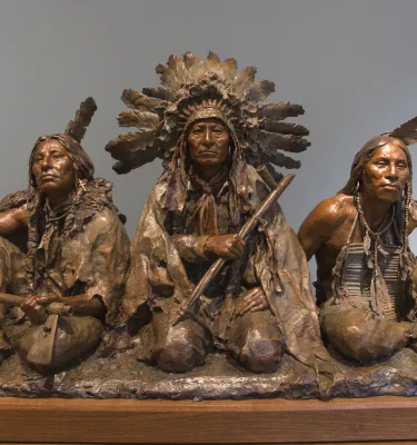 A bronze sculpture of Native American warriors