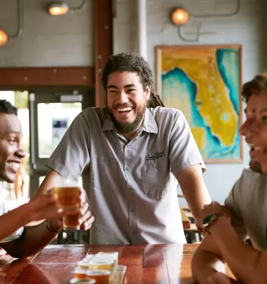 A group of friends enjoying drinks at Green Bench Brewery in St. Pete