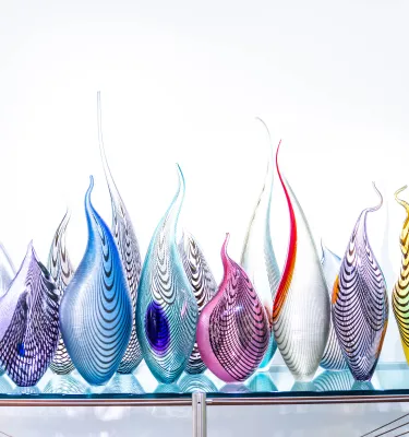Colorful glass sculpture looking like fire flames at Imagine Museum