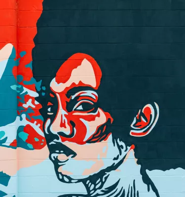 An African-American woman painted in red and blue in a mural in St. Pete