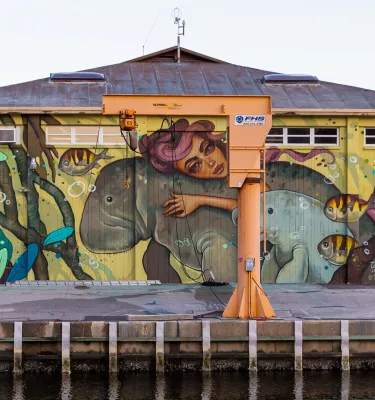 Mural showing a mermaid and manatees painted in St. Pete Marina