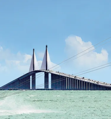 A man kiteboards at the Skyway Bridge