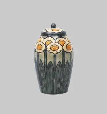 A lidded ceramic jar with hand-painted daisies.