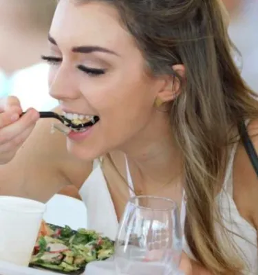 A woman eats a salad at Savor The Burg