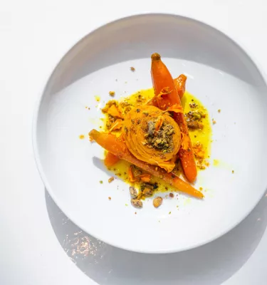 an artfully designed plate of food including carrots, spices and a sweet potato at Cafe Gala at the Dali Museum in St. Pete