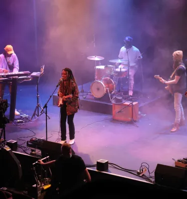 Photo of five musicians playing on stage at the Bilheimer Capitol Theatre in Clearwater. Photo features include purple lighting and stage fog. 
