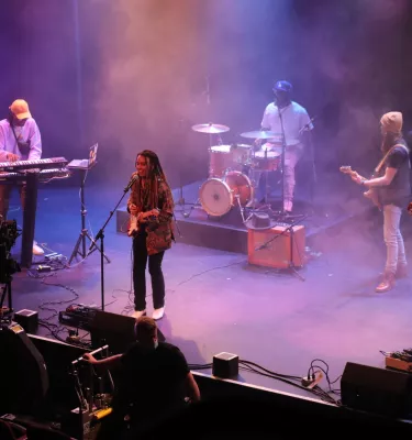 Photo of five musicians playing on stage at the Bilheimer Capitol Theatre in Clearwater. Photo features include purple lighting and stage fog. 