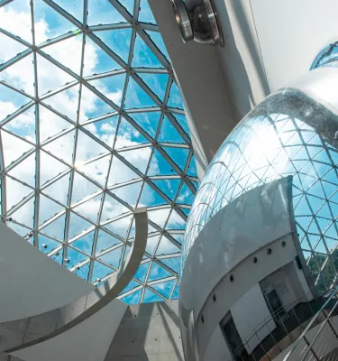 blue key and clouds seen through the curved windows of the "enigma" which is part of the Dali Museum in St. Pete Florida