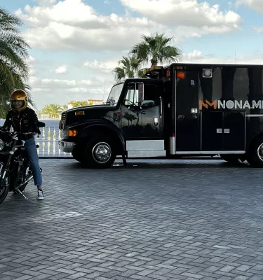 Two people getting set up for a motorcycle scene