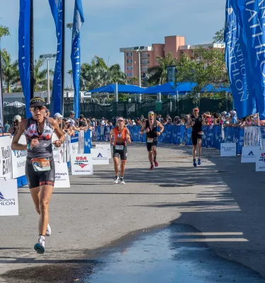 Four racers running outside during the day in the St. Anthony's Triathlon competition.