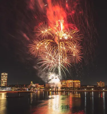 Red and white fireworks explode over the St. Pete skyline
