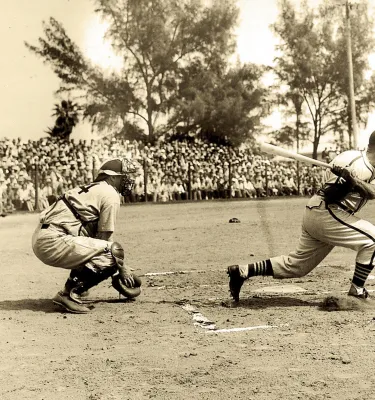 Sepia-toned photo of a batter, catcher and umpire from 1938