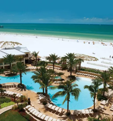 Sandpearl pool with palm trees and beach