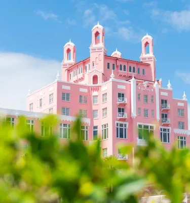 The Don CeSar Hotel with green bushes in the foreground