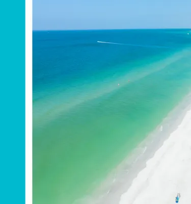 an aquamarine blue rectangle next to an aerial photo of the beach