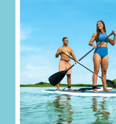 a light blue box next to a couple paddleboarding