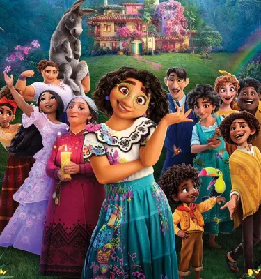 Image of the fictional cartoon characters of the movie Encanto featuring a rainbow and a pink house in the background.