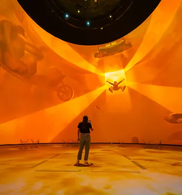 Dome projection with woman in front of it 