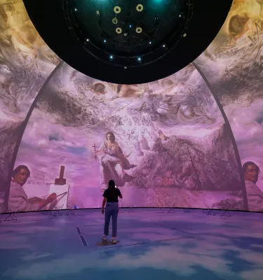 Dome projection with woman in front of it 