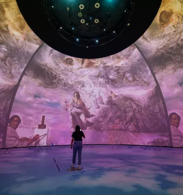 Dome projection with woman in front of it 